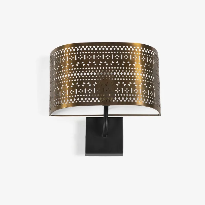 Front view of gold perforated wall lamp with black rectangular mount