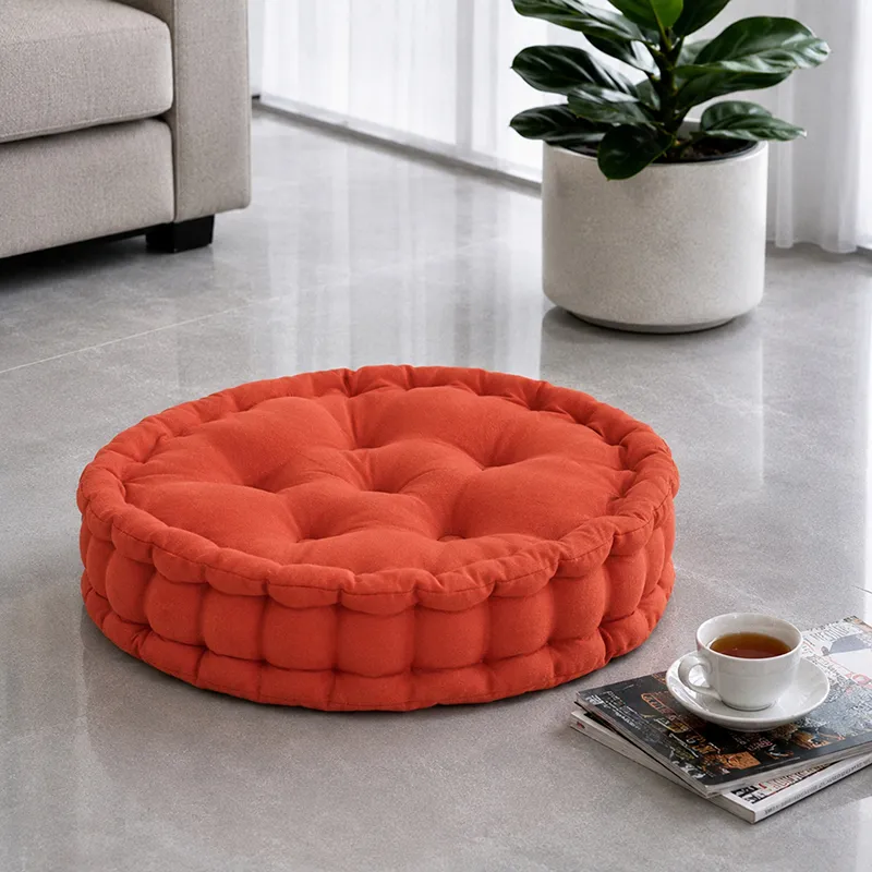 Round terracotta floor cushion styled on a living room floor