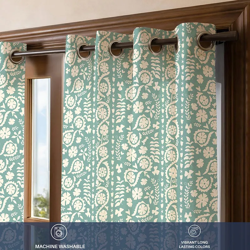 Close-up of green floral curtain with eyelet heading and printed pattern