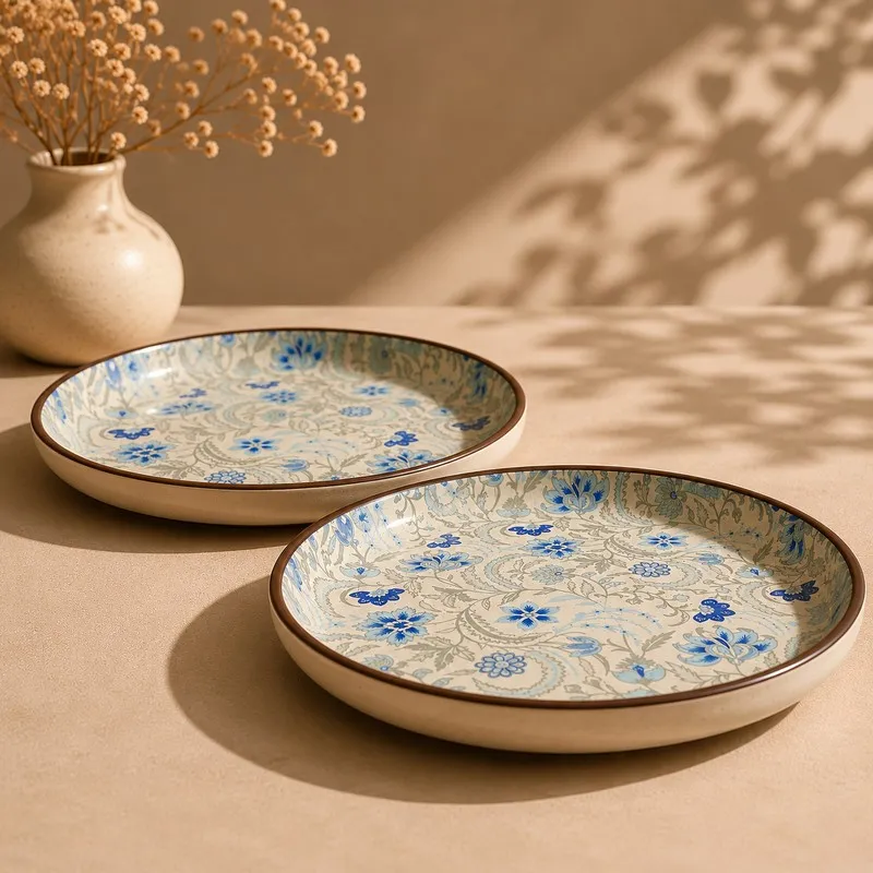 Two ceramic dinner plates with blue floral pattern placed on a tabletop