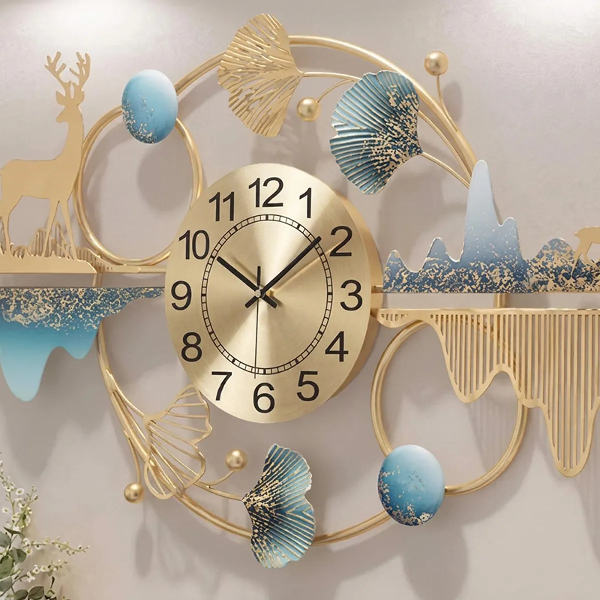 Close view of gold analog clock face with blue and gold decorative metal accents