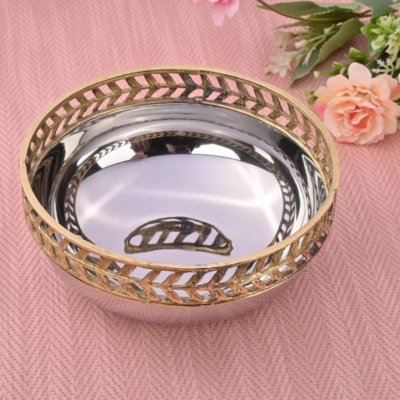 Glossy silver and gold accent bowl styled on a pink textured surface