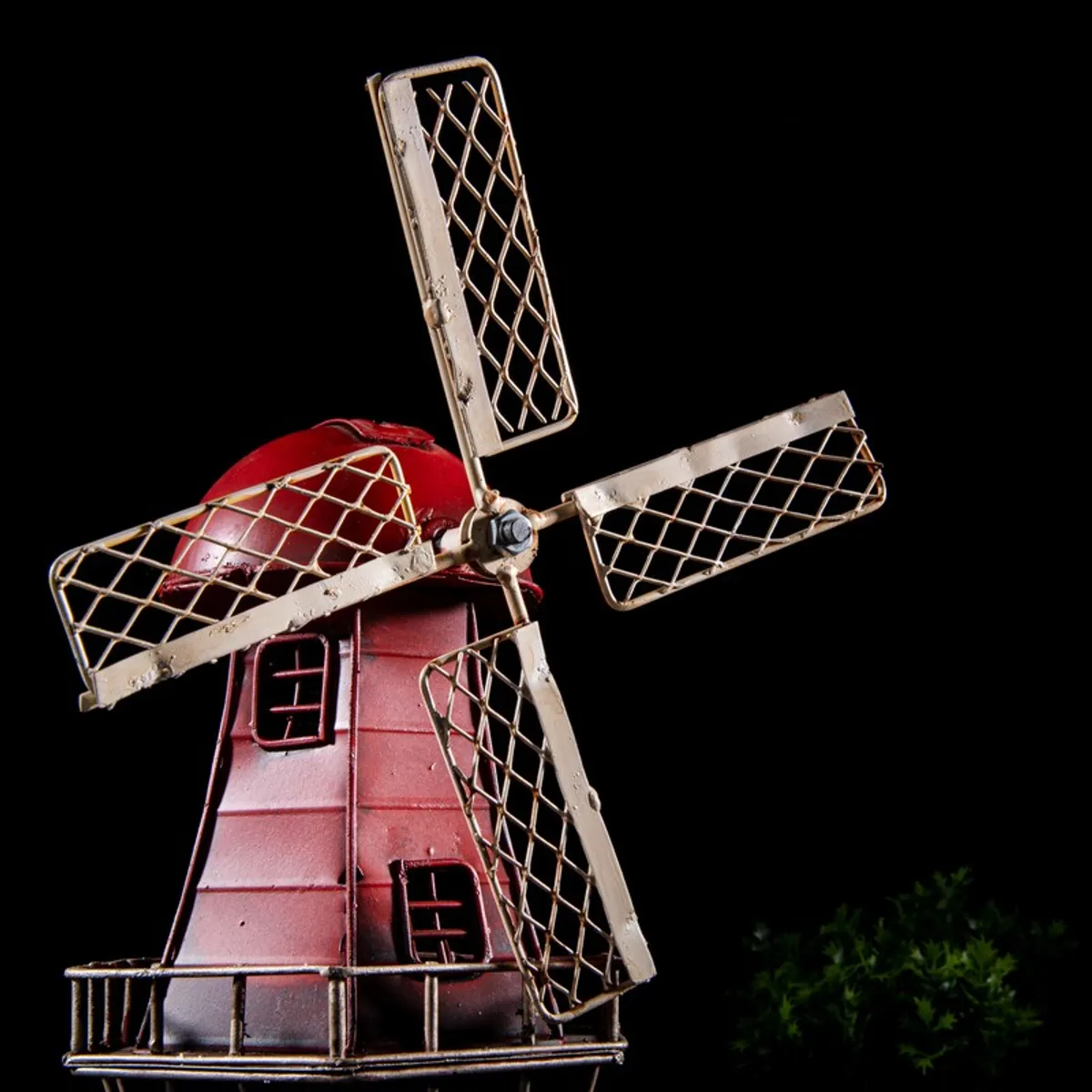Close angled view of the red windmill blades and body