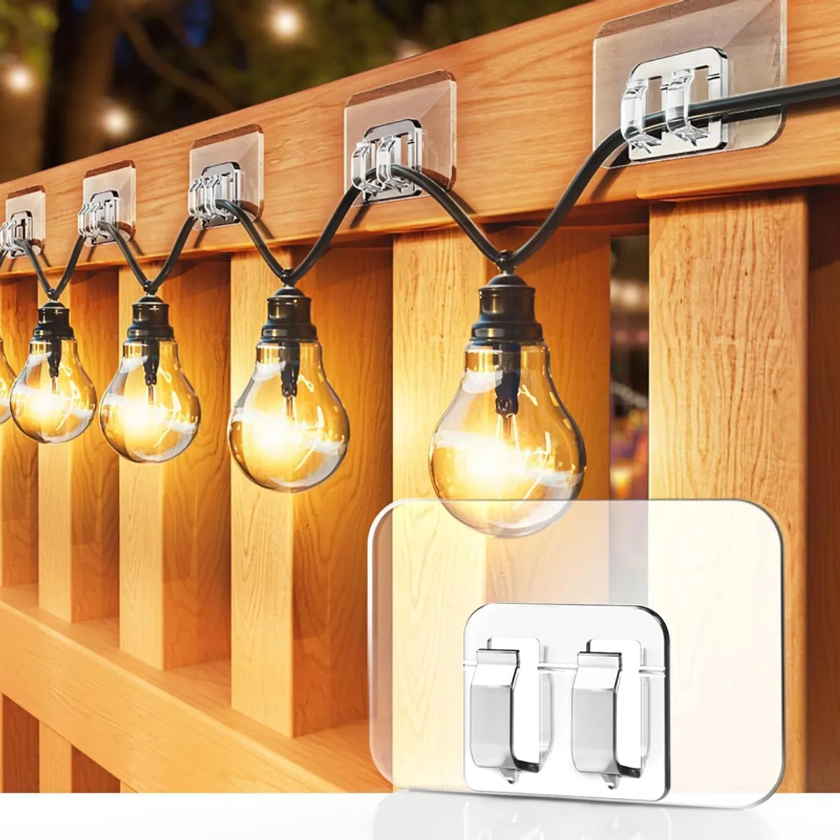 Transparent adhesive hooks mounted on a wooden railing with string lights