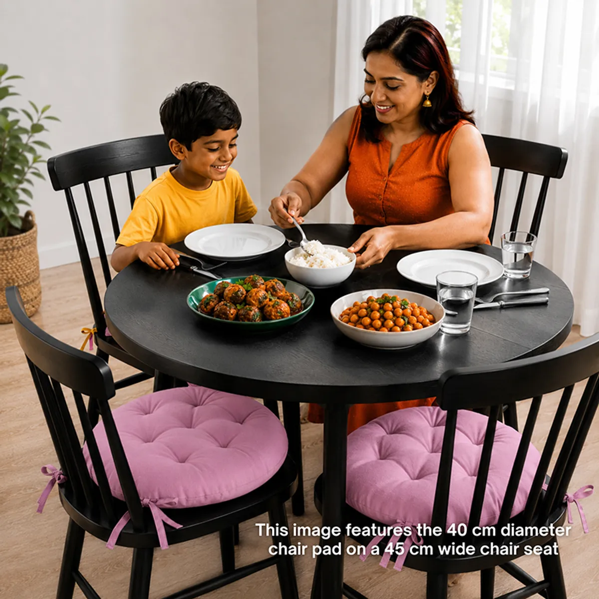 Lilac round chair pads used on black dining chairs around a table