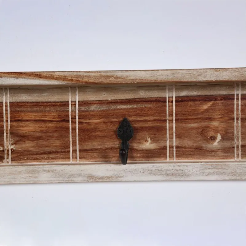 Close-up of the wooden panel and single black hook detail