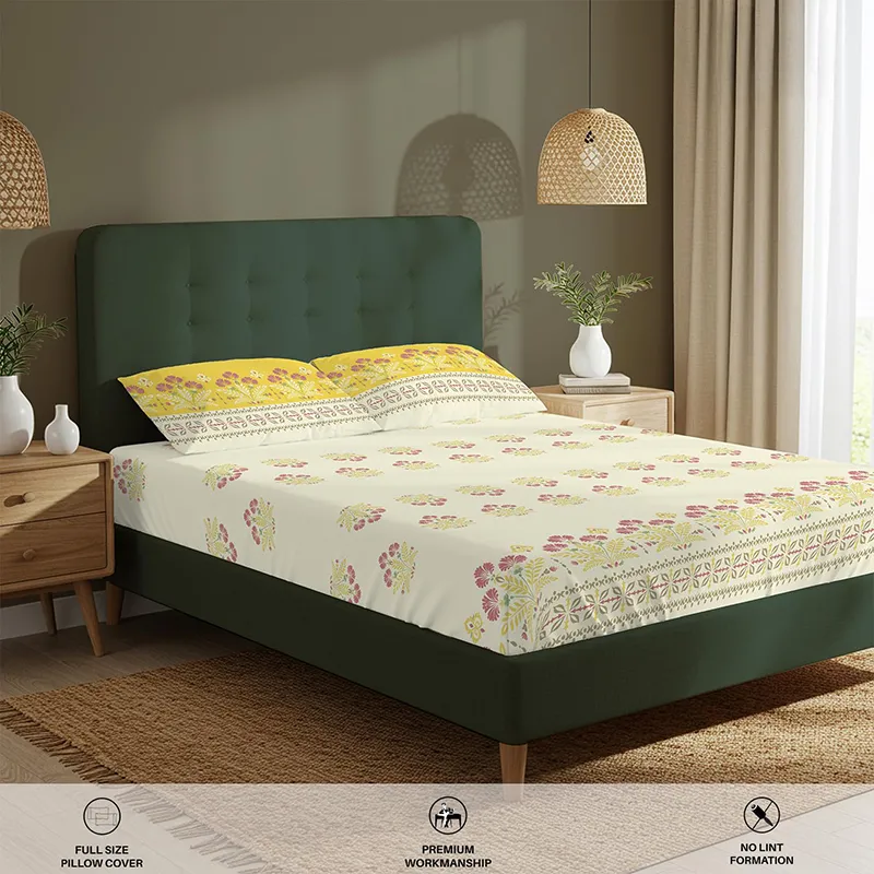 Angled room view of yellow floral fitted bedsheet with matching pillow covers