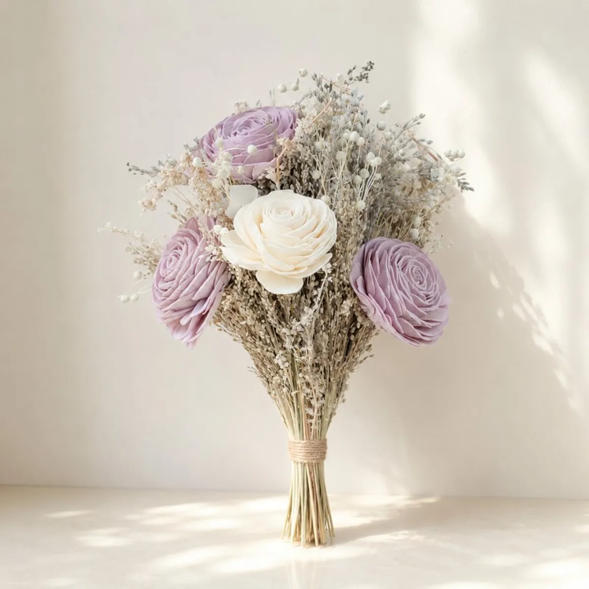 Lilac and off-white posy bunch tied at the stems against a light background