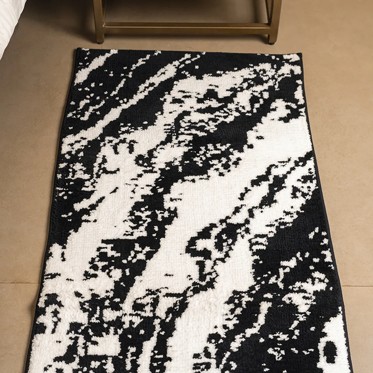 Close view of the black and white abstract pattern on the rectangular runner rug.
