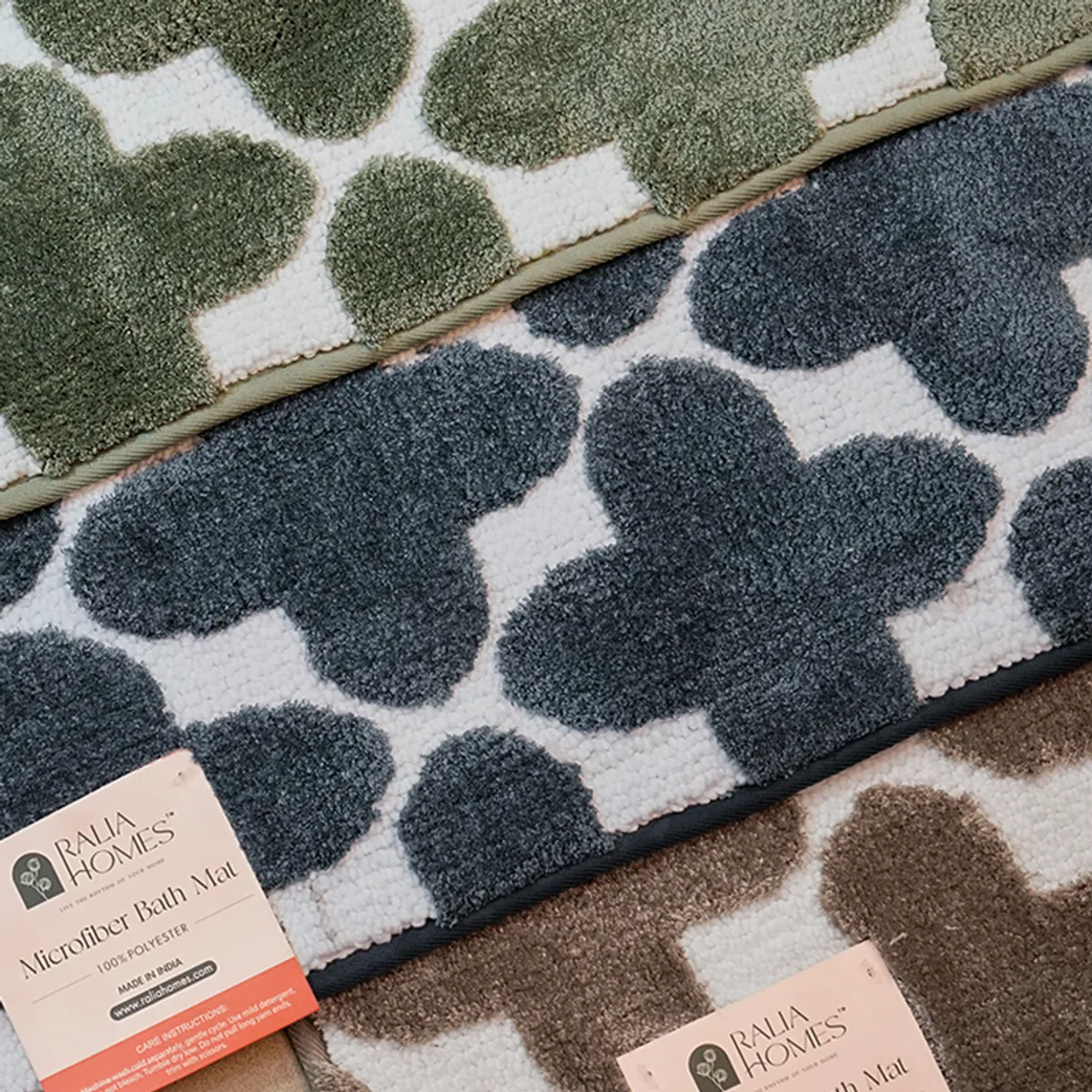Blue, green and brown geometric bath mats displayed together