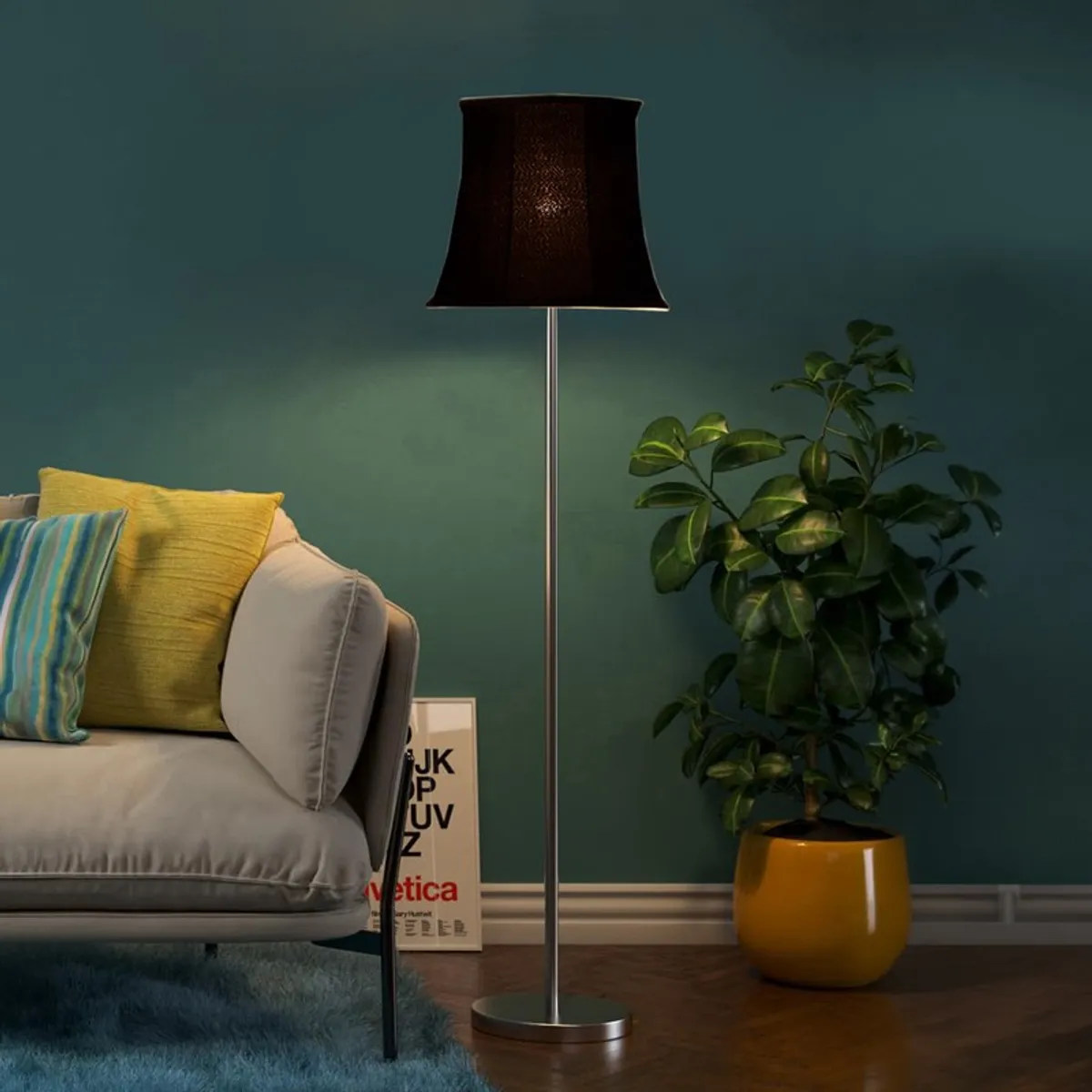 Black floor lamp glowing softly beside a sofa and potted plant