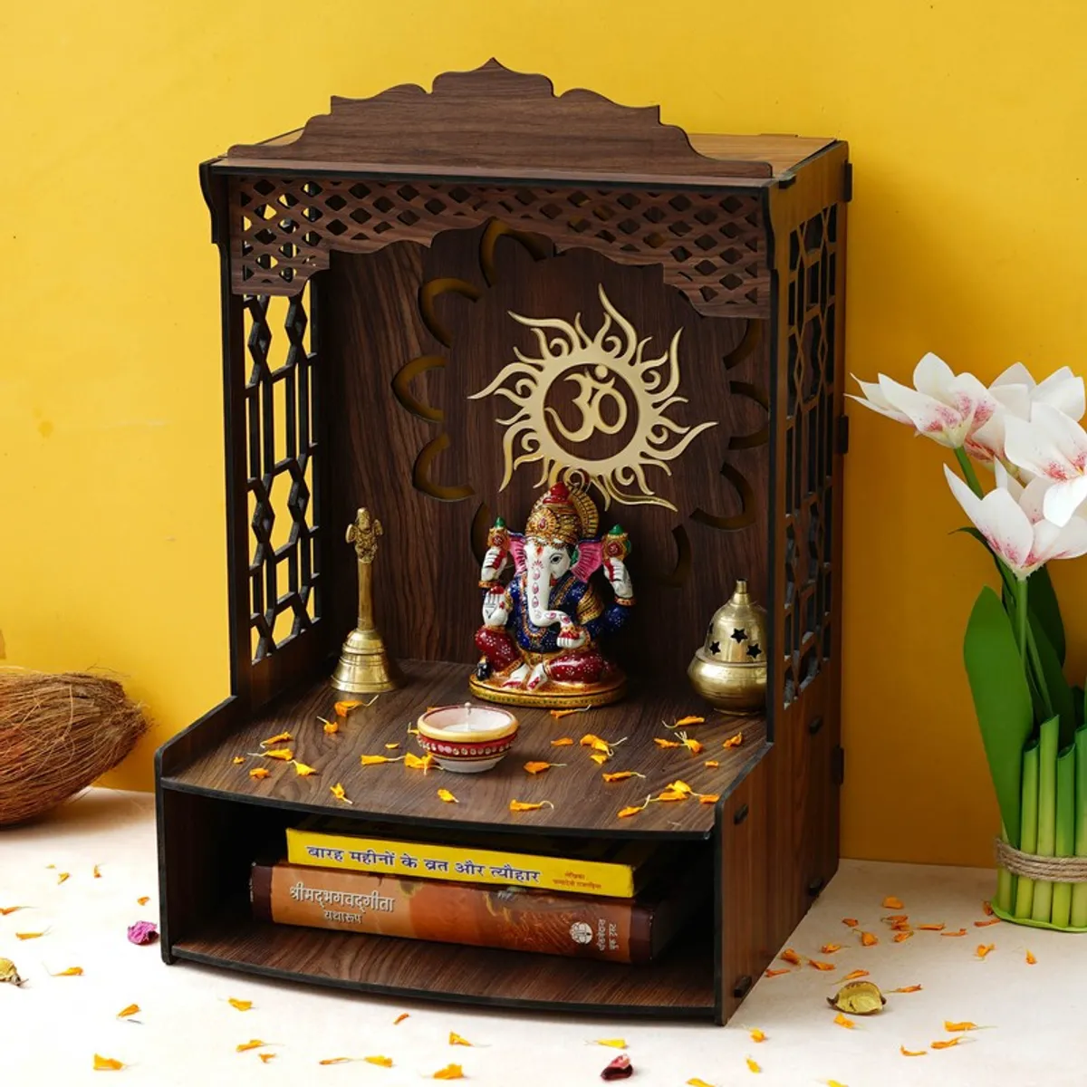 Angled view of brown wooden mandir with carved side panels and shelf