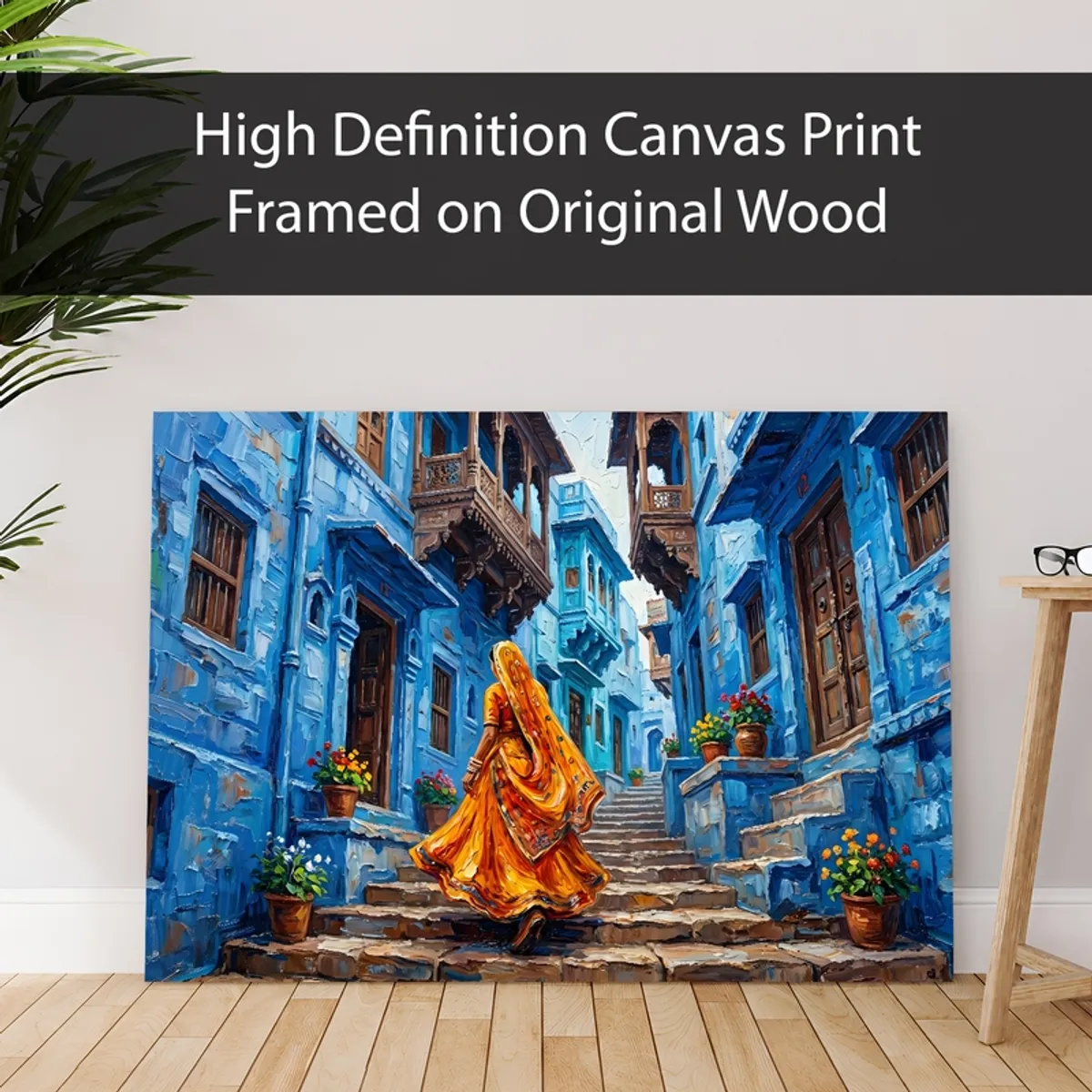 Blue city canvas print leaning against a wall in a styled room setting