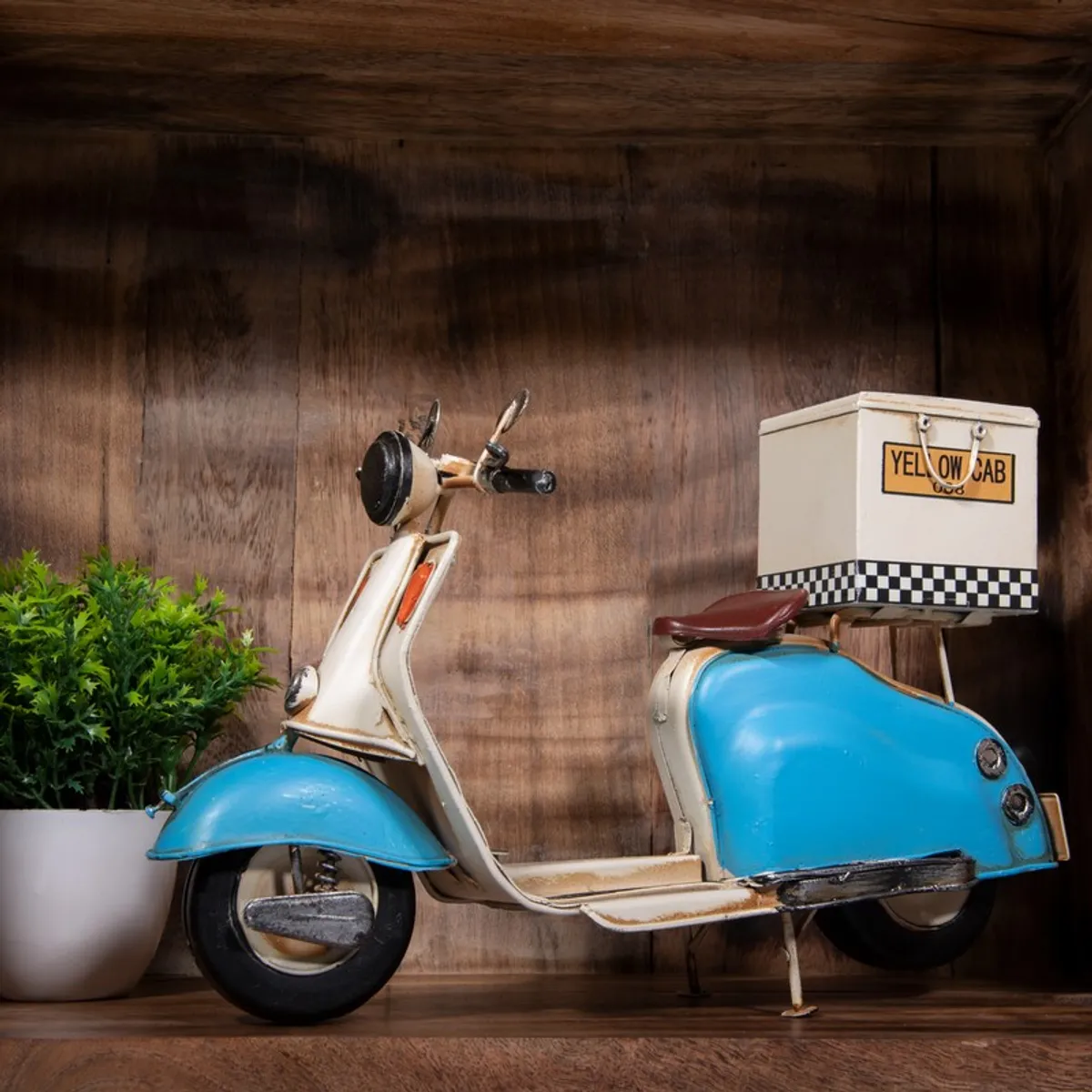 Side view of a blue and cream scooter showpiece with rear delivery box