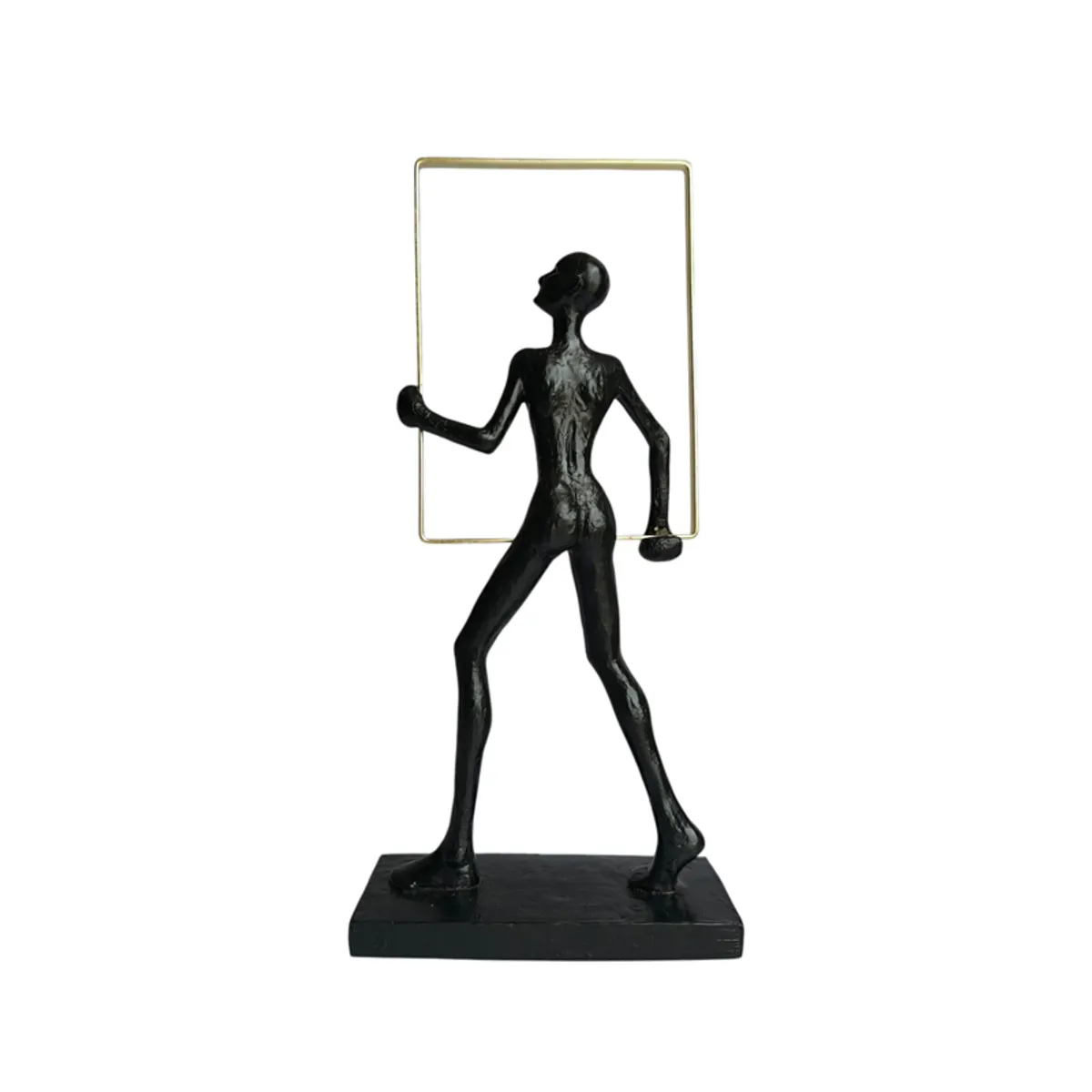 Rear view of a black abstract human figurine with a gold frame