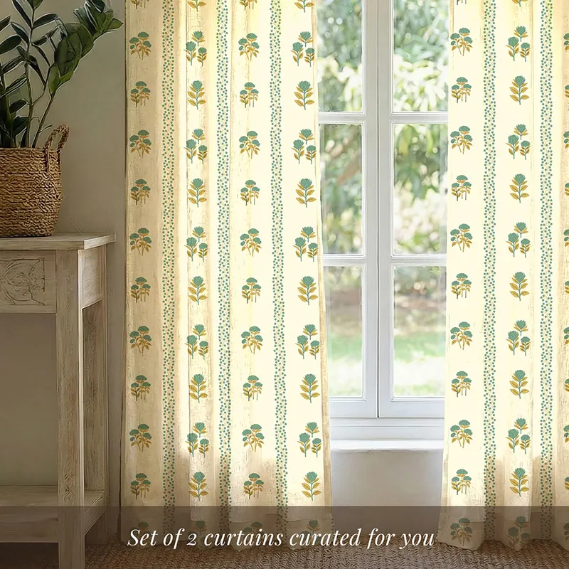 Set of floral printed sage green curtains at a window