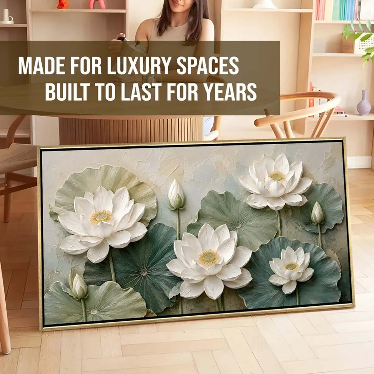 Framed white lotus canvas painting leaning on the floor in a styled room