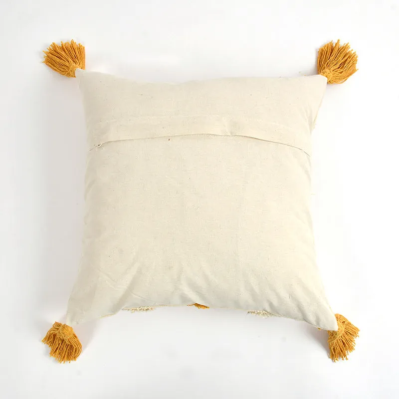 Back view of a cream cushion cover with mustard corner tassels