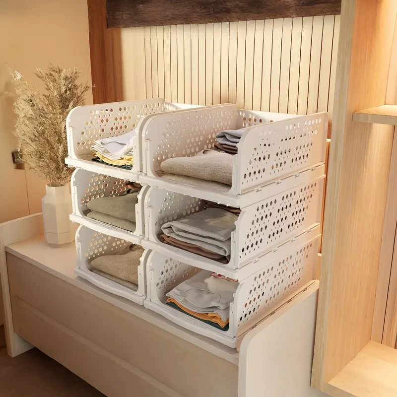 Stack of white perforated organisers filled with folded clothes