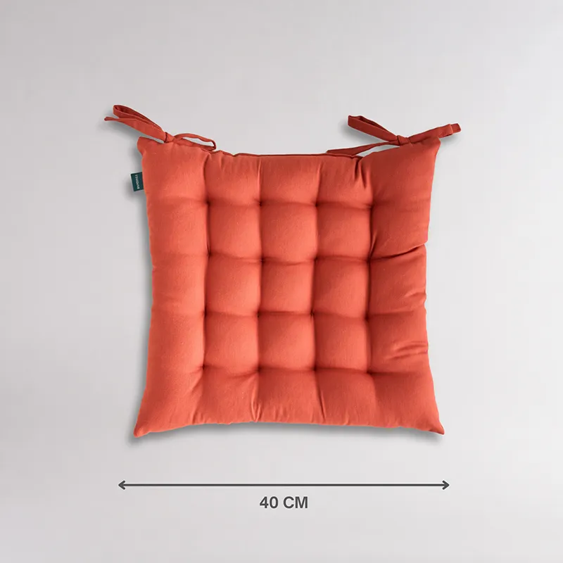 Front view of square terracotta brown chair pad with tie-up corners