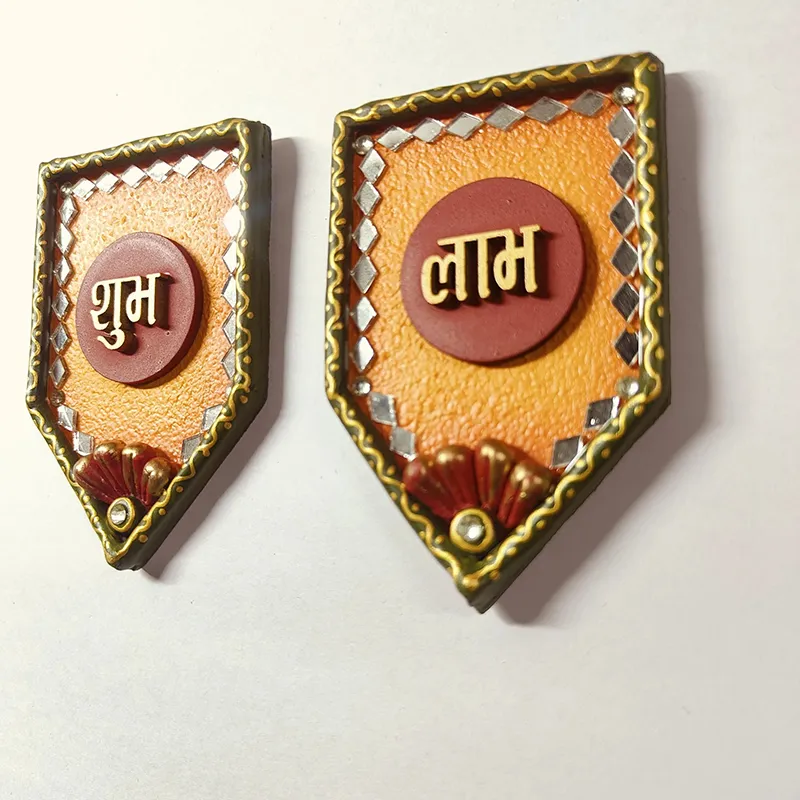 Angled view of the Shubh Labh wall accent set in orange, red and gold tones