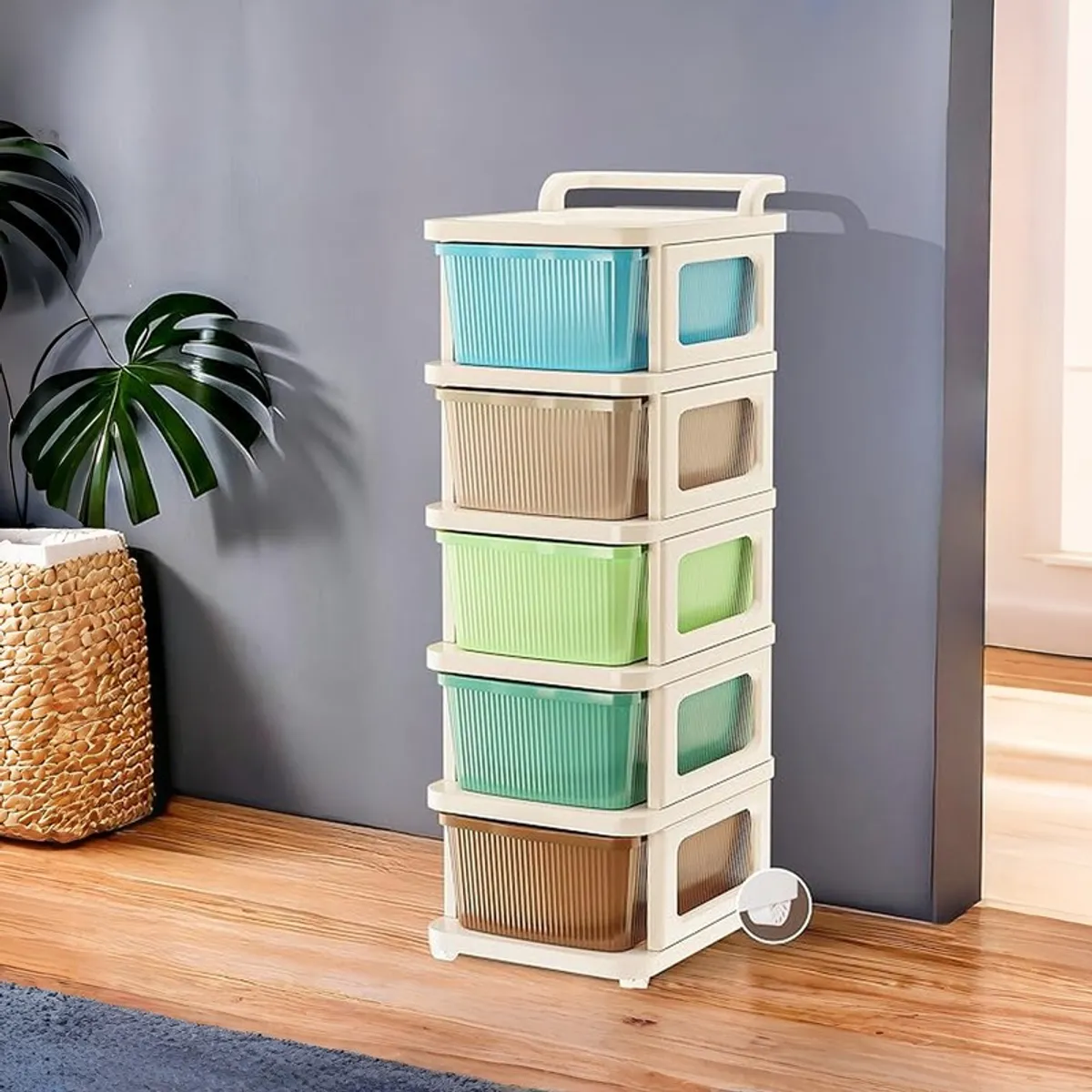 Multicolour storage rack with five drawers and wheels against a dark wall