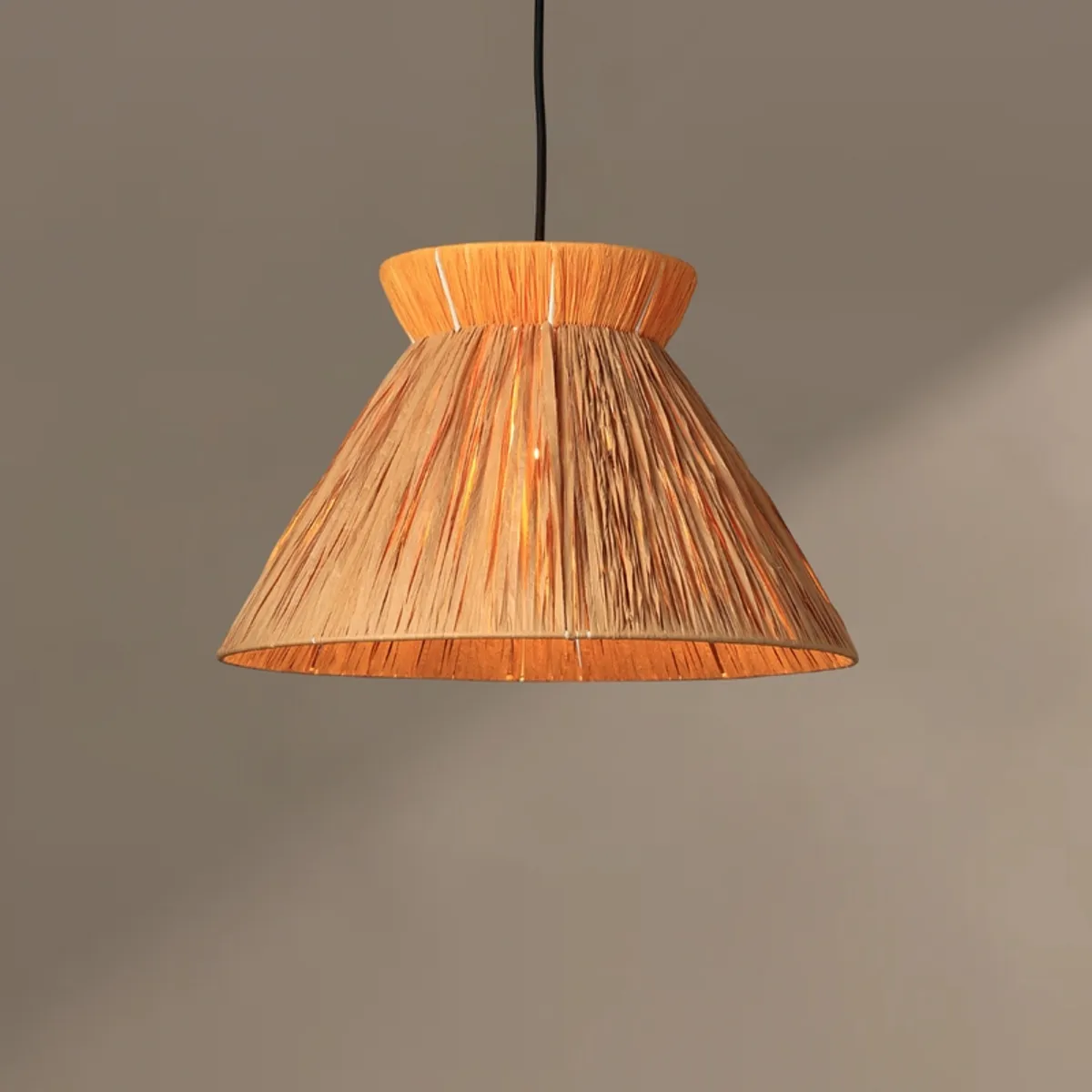 Orange and brown rattan pendant lamp against a plain wall