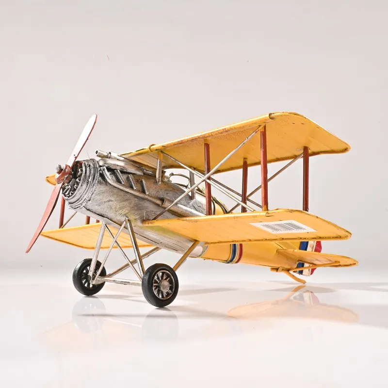 Yellow iron biplane showpiece photographed on a white background