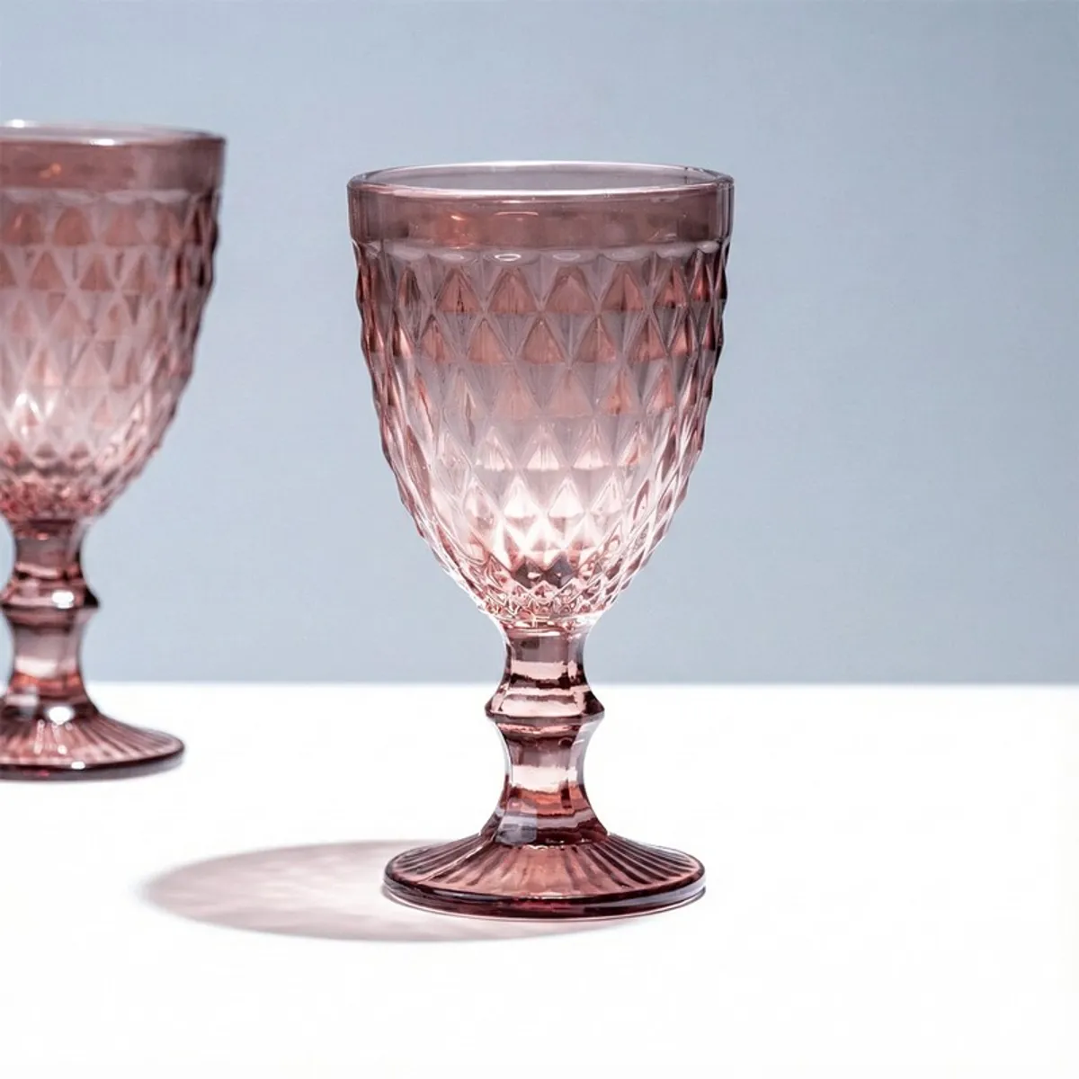 Close-up of a single pink textured stemmed wine glass