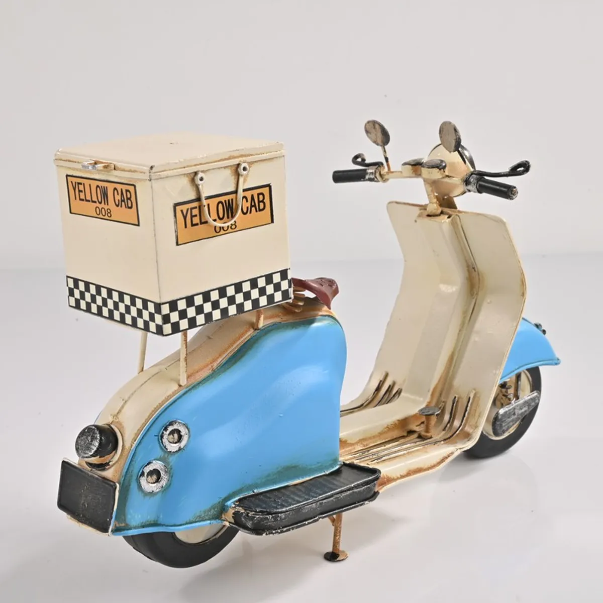 Back angled view of scooter showpiece with box detail on white background