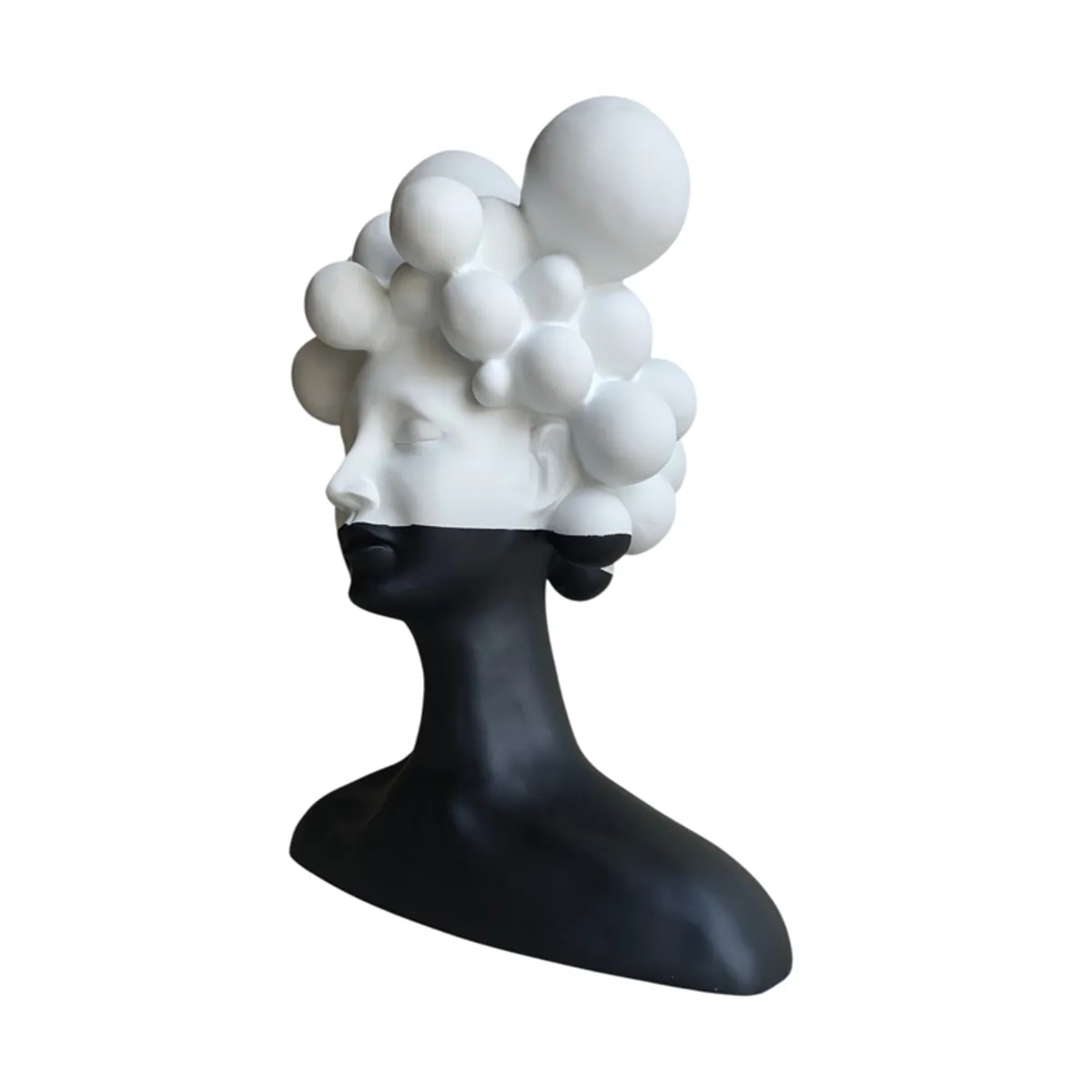 Angled view of a black and white female bust sculpture