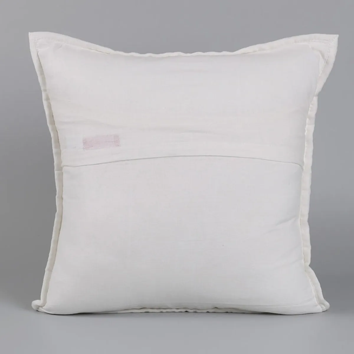 Plain white back of a square cushion cover