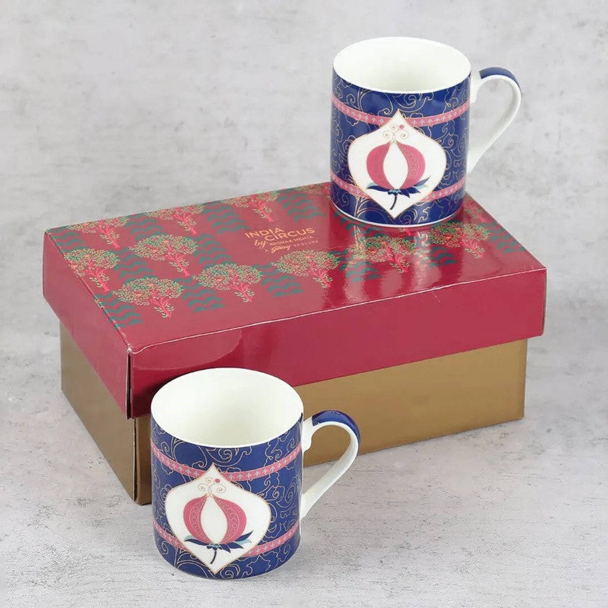 Two matching decorative mugs displayed with their gift box