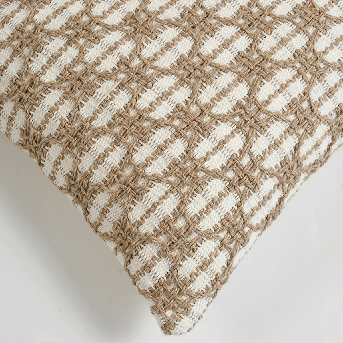 Close-up of the cushion cover's textured white and beige surface