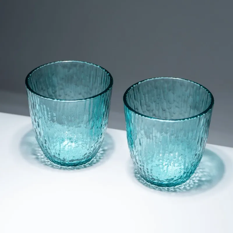 Pair of blue textured drinking glasses viewed from above angle