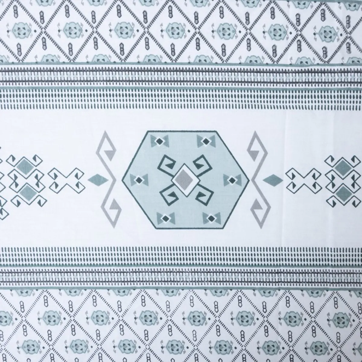 Close-up of blue and white geometric motif on the bedsheet