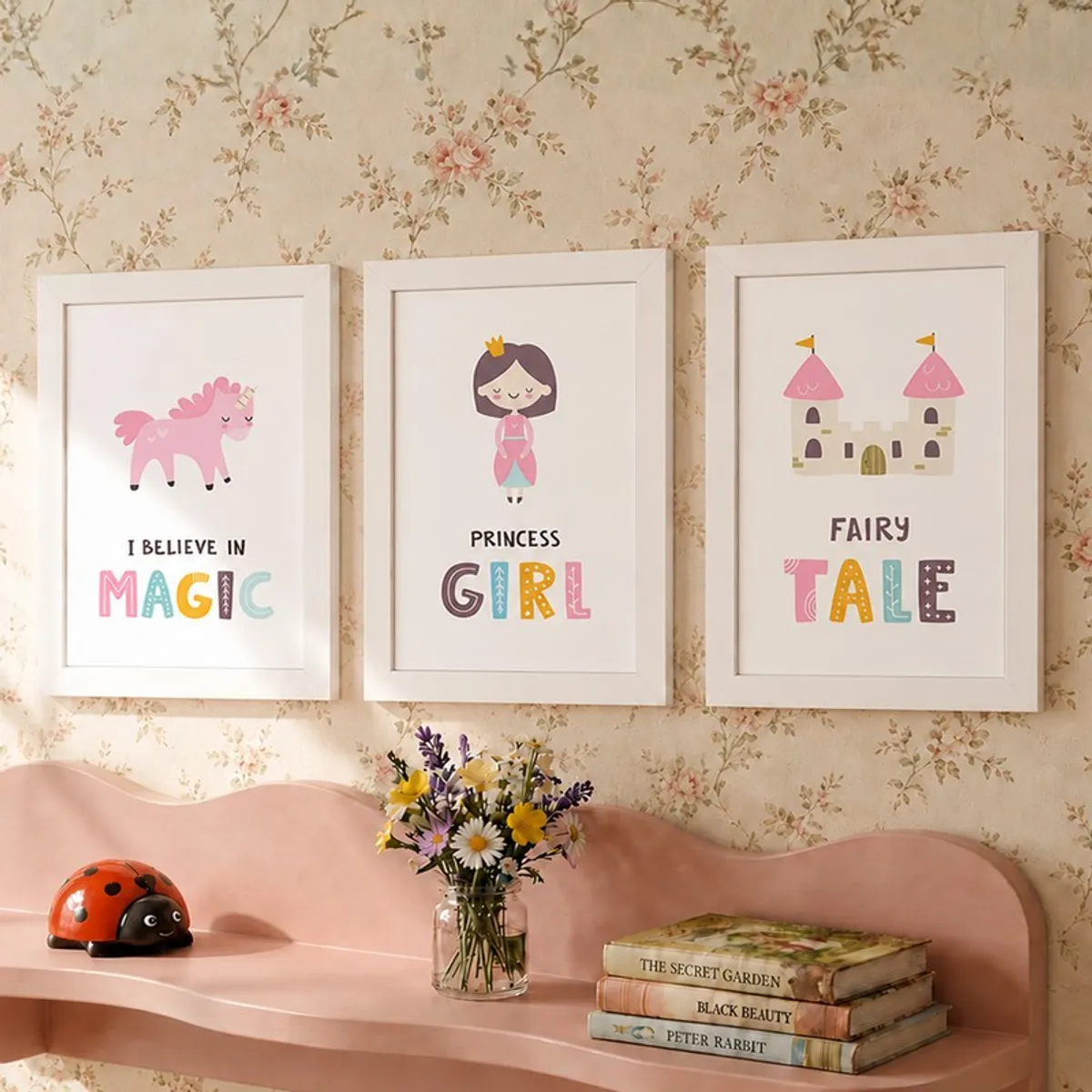 Framed fairy princess wall art set of three on a floral wallpapered wall