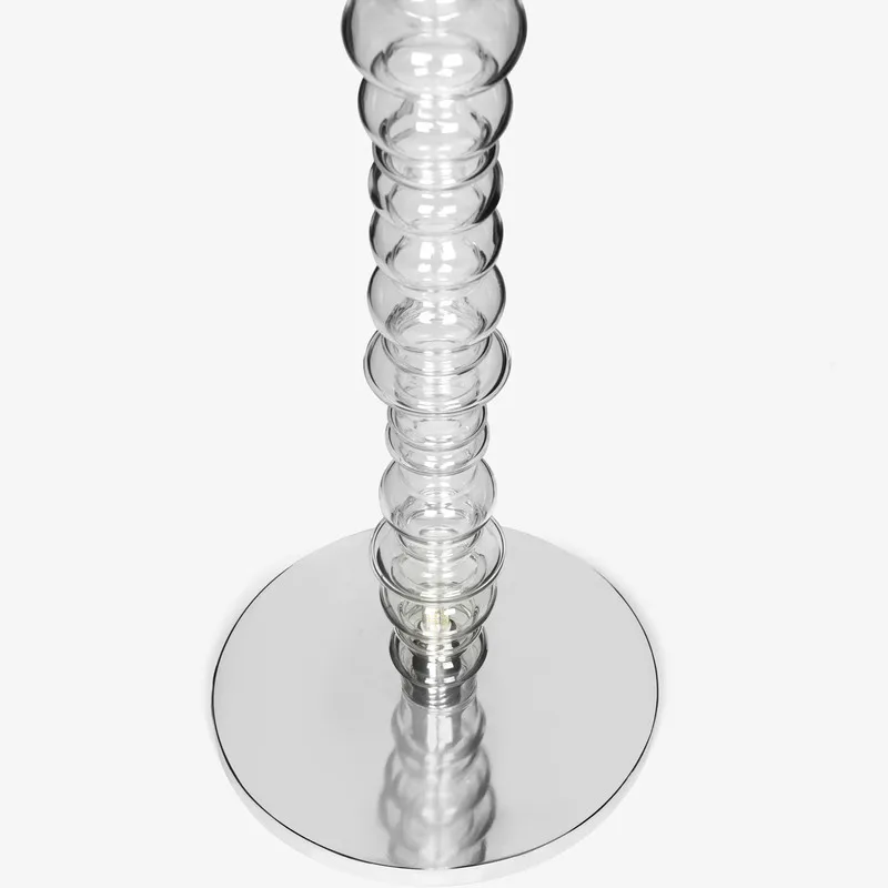 Close-up of the lower glass stem and round silver base