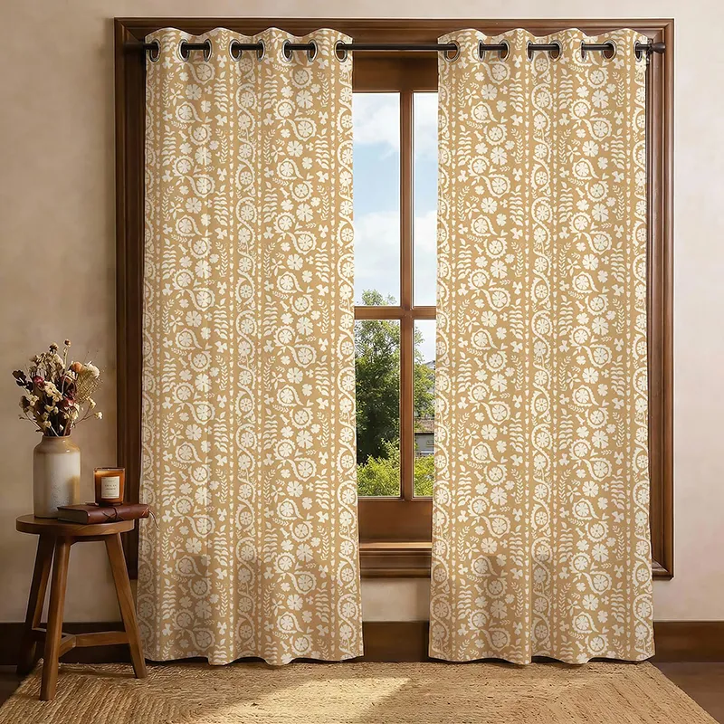 Set of two beige floral printed curtains hanging on a wooden window
