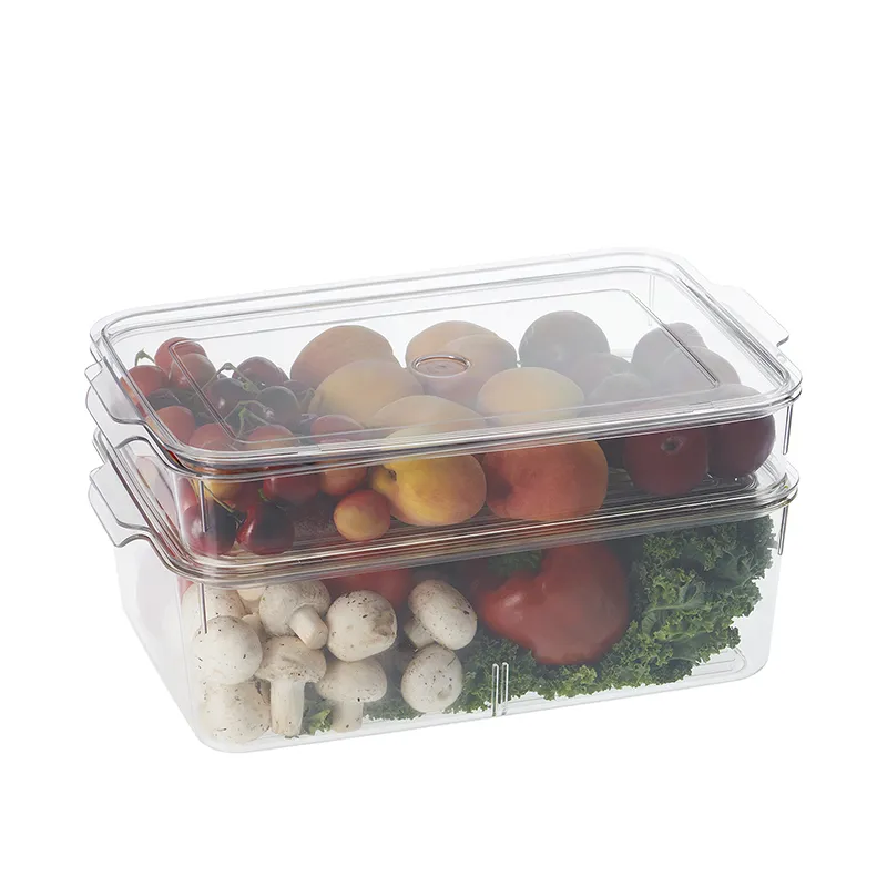 Stacked clear fridge organisers filled with fruit, mushrooms, peppers and greens.