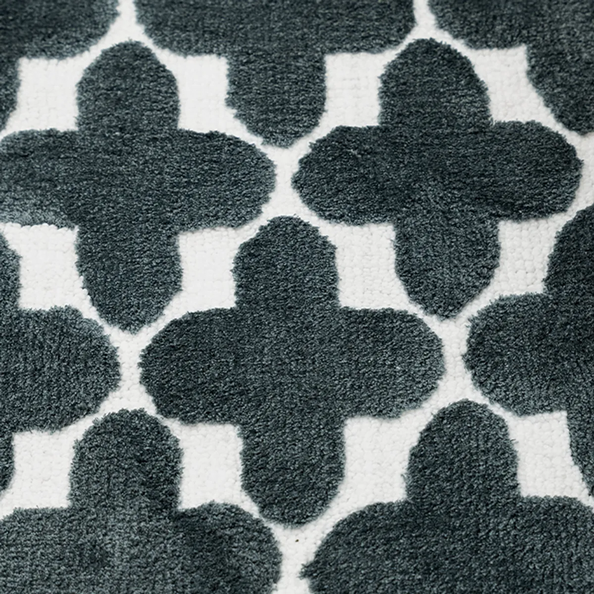 Detail of the blue and white clover geometric bath mat pattern