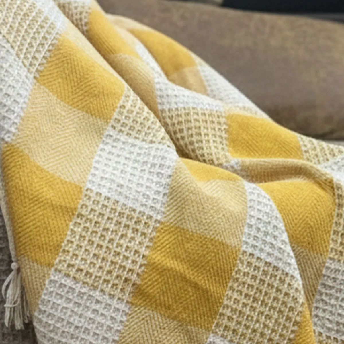 Close-up view of the yellow and white textured throw