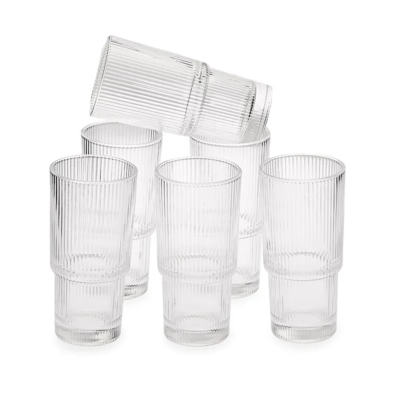 Set of six clear ribbed cylindrical glasses on a white background