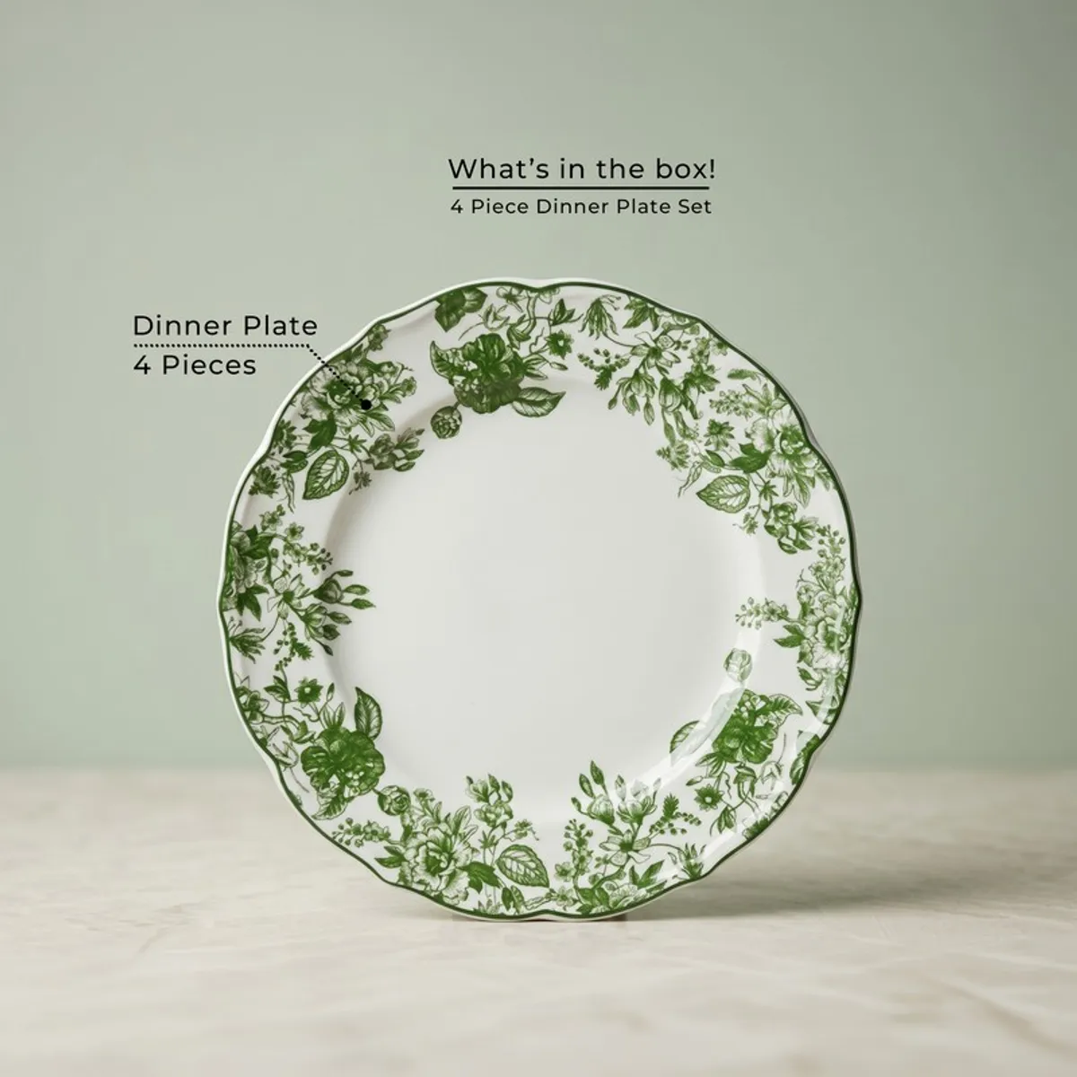Single round dinner plate with green floral border on a white base