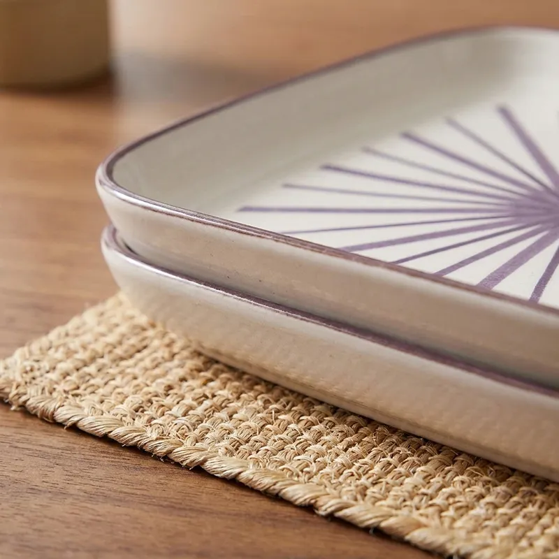 Close-up of the rim and side profile of the square porcelain plate