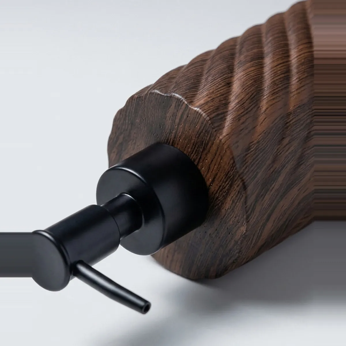 Close-up of brown textured soap dispenser with black pump