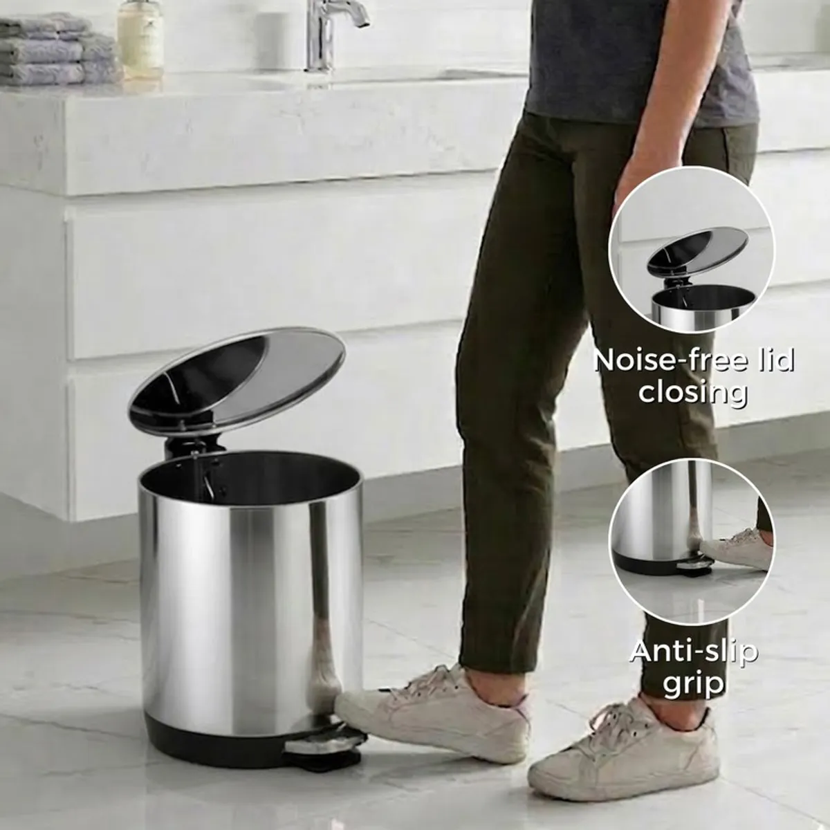 Silver pedal dustbin with open lid shown in a bathroom setting