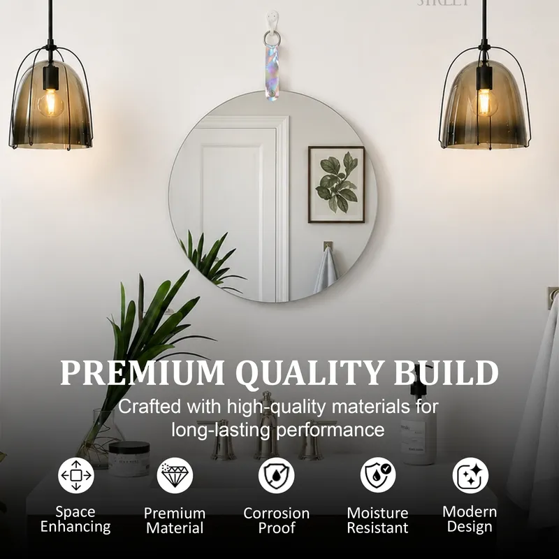 Round frameless mirror styled on a wall between two pendant lights