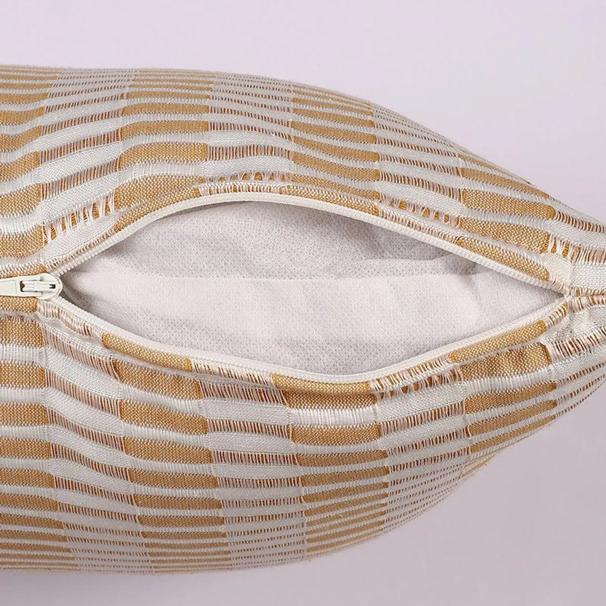 Close-up of cushion cover zip closure and textured striped cotton fabric