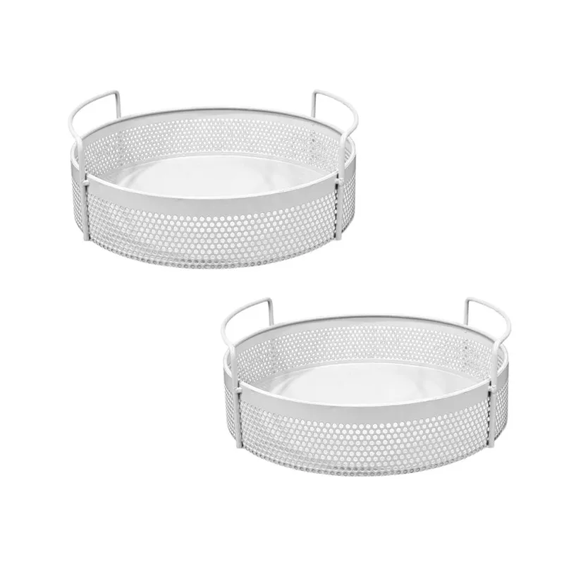 Set of two white round metal baskets with side handles on a plain background